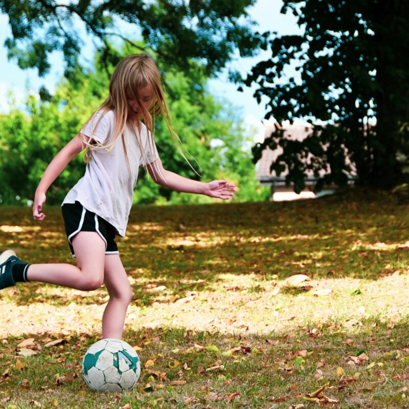 girl in sports playing soccer