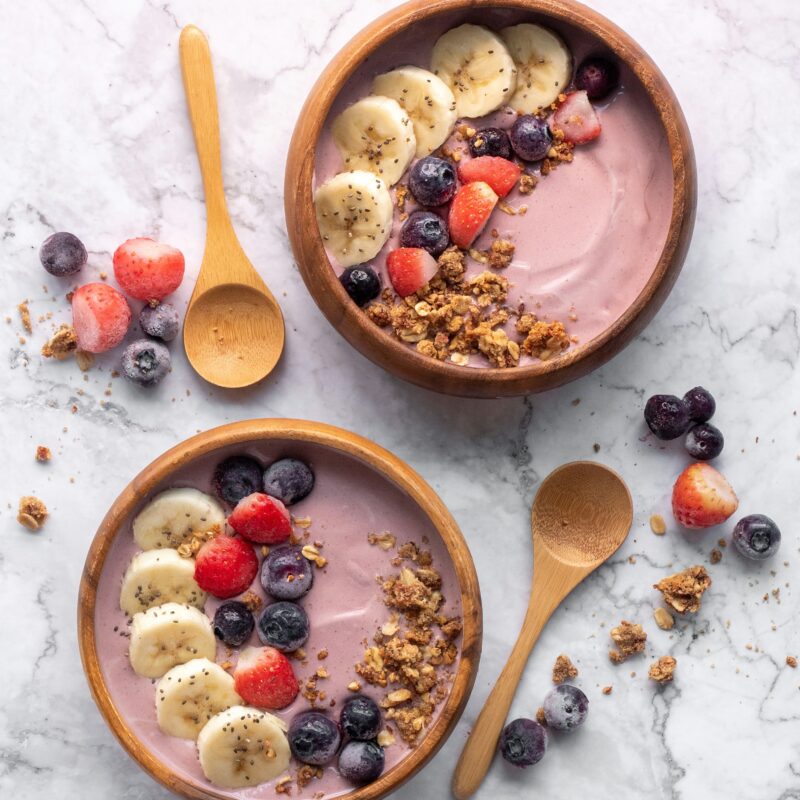 graceful photo of acai bowl with granola and berries including banana