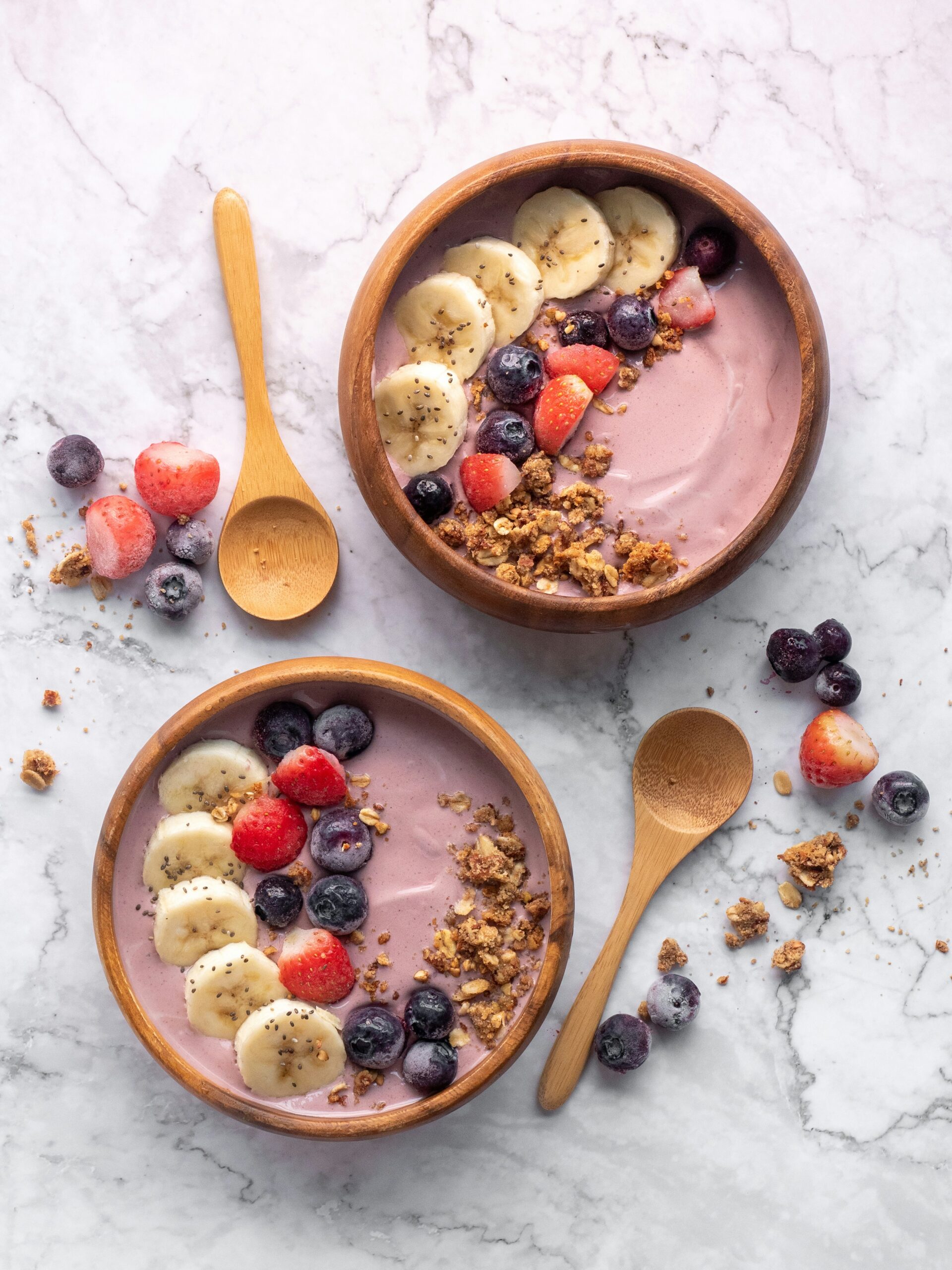 graceful photo of acai bowl with granola and berries including banana